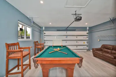 a living room with a pool table and a couch at Spacious 4 bedrooms, 2 bathroom house with pool in Miramar