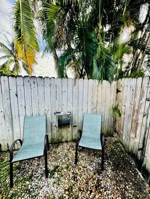 two chairs sitting in front of a fence at Modern Home - Termpurpedic Queen bed, Laundry, Free Parkging, EV Tesla in Hollywood