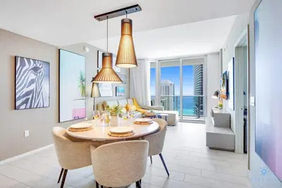 a dining room and living room with a table and chairs at Oceanfront Oasis, Luxury, Sunrise Views, Resort in Hollywood