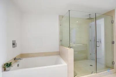 a bathroom with a tub and a glass shower at Oceanfront Oasis, Luxury, Sunrise Views, Resort in Hollywood