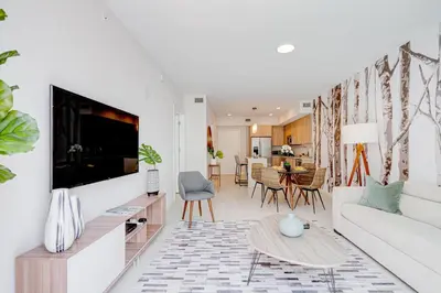 a living room with a couch and a tv at 3900-719JC DESIGN DISTRICT, CONDO 1 BEDROOM /1 BATHROOM & BAYVIE in Miami