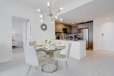 a kitchen and dining room with a table and chairs at 805MM DOWNTOWN DORAL CONDO 2 BEDROOMS & 2 BATHROOMS in Miami