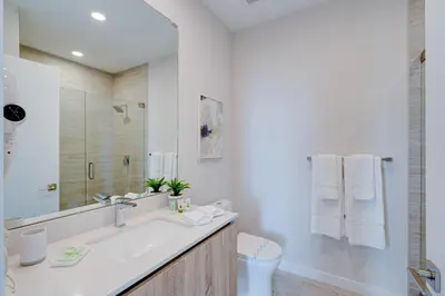 a white bathroom with a sink and a toilet at 3900-502GJ DESIGN DISTRICT, CONDO 2 BEDROOMS & 2 BATHROOMS in Miami