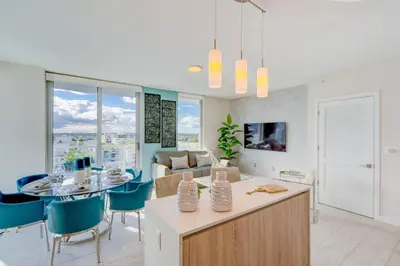 a kitchen and living room with a table and chairs at 3900-902CH DESIGN DISTRICT, CONDO 2 BEDROOMS & 2 BATHROOMS in Miami