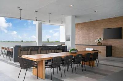 a dining room with a large wooden table and chairs at 3900-717AS DESIGN DISTRICT, CONDO 2 BEDROOMS & 2 BATHROOMS & BAY in Miami