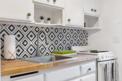 a kitchen with a sink and a geometric wallpaper at Lake Ridge Villa - Free Parking in Fort Lauderdale