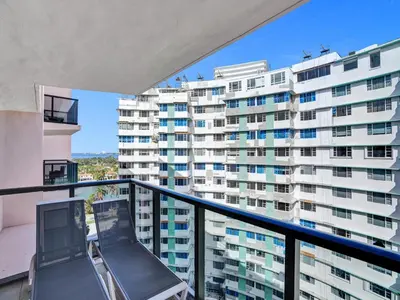 a balcony with a view of a large building at High floor Oceanview condo 1506 in Miami Beach