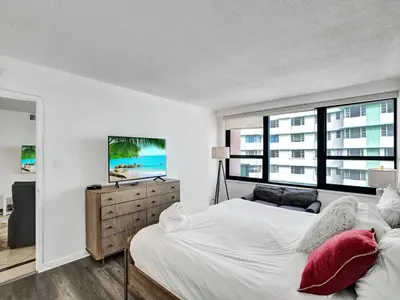 a bedroom with two beds and a large window at High floor Oceanview condo 1506 in Miami Beach