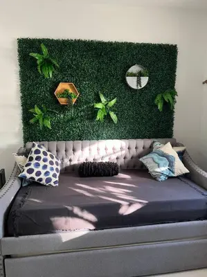 a bedroom with a bed with plants on the wall at Modern apartment steps the beach in Miami Beach