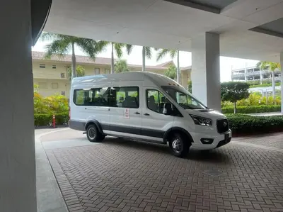 a small white van parked under a building at Bright Miami Beach Stay with Amazing Views, Full Kitchen -A in Hallandale Beach