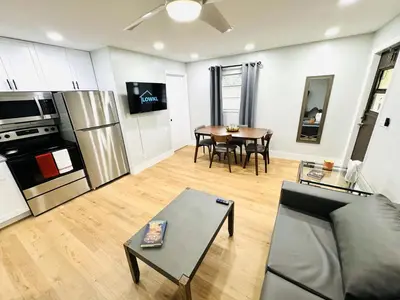 a living room with a couch and a table at Progresso Apartments & Homes by Lowkl in Fort Lauderdale
