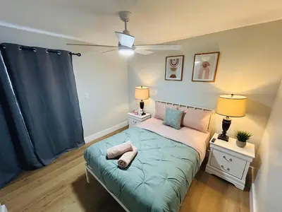 a bedroom with a bed with a blue comforter at Progresso Apartments & Homes by Lowkl in Fort Lauderdale