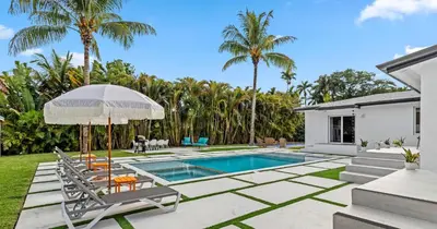 a backyard with a swimming pool and palm trees at New Spectacular 6BR Bliss - Pool - Spa & Pickell in Miami