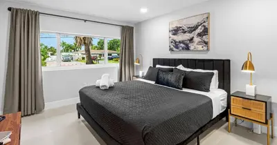 a bedroom with a bed and a large window at New Spectacular 6BR Bliss - Pool - Spa & Pickell in Miami
