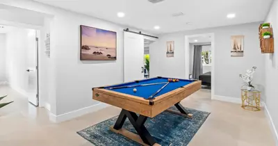 a pool table in the middle of a living room at New Spectacular 6BR Bliss - Pool - Spa & Pickell in Miami
