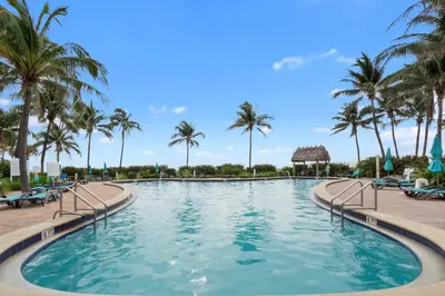 a pool at a resort with palm trees at Tides in Hollywood Beach By My Miami Vacation in Hollywood