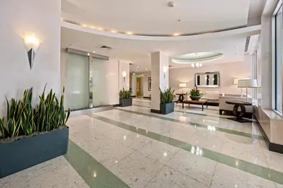 an empty lobby with plants in a building at Tides in Hollywood Beach By My Miami Vacation in Hollywood