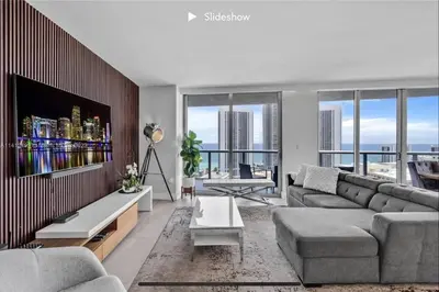 a living room with a couch and a tv at Apartment 3B/3B Bay View in Hallandale Beach