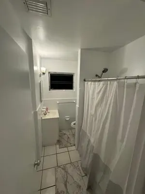 a bathroom with a shower and a sink and a window at Beautiful Home in Florida in Hollywood