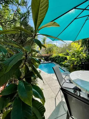a patio with a table and a swimming pool at Delight and cozy Apt close to Las Olas & the beach in Fort Lauderdale