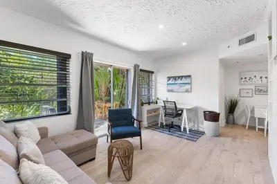 a living room with a couch and a table at Delight and cozy Apt close to Las Olas & the beach in Fort Lauderdale