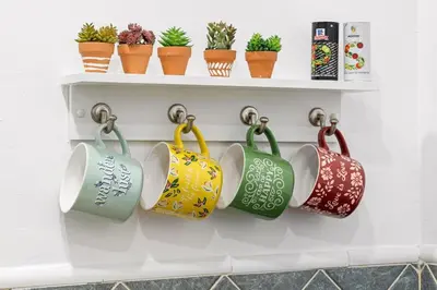 a rack of coffee cups on a wall with plants at Welcoming Airbnb Walkig distance to Las Olas Blvd in Fort Lauderdale