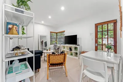 a living room with a table and a dining room at Beautiful Apt in Victoria Park (Las Olas Blvd) in Fort Lauderdale
