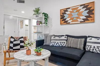 a living room with a blue couch and a table at Beautiful Apt in Victoria Park (Las Olas Blvd) in Fort Lauderdale