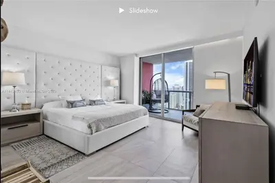 a bedroom with a large bed and a television at Apartment 3B/3B Bay View in Hallandale Beach