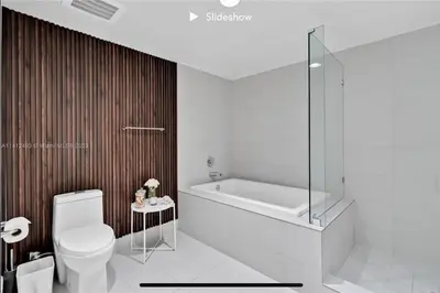 a bathroom with a tub and a toilet and a shower at Apartment 3B/3B Bay View in Hallandale Beach