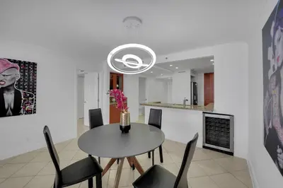 a dining room and kitchen with a table and chairs at Ray of Light! Miami Penthouse! in Miami