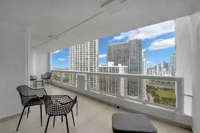 a balcony with chairs and a view of a city at Ray of Light! Miami Penthouse! in Miami