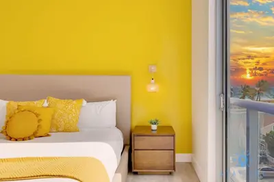 a yellow bedroom with a bed and a window at Lovely Apt for 6 - Hollywood Beach Broad - walk in Hollywood