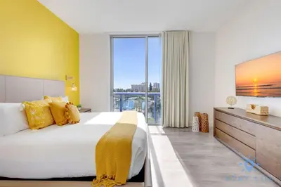 a bedroom with a large bed and a large window at Lovely Apt for 6 - Hollywood Beach Broad - walk in Hollywood