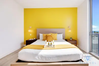 a bedroom with a large bed with a yellow wall at Lovely Apt for 6 - Hollywood Beach Broad - walk in Hollywood