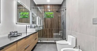 a bathroom with a shower and a toilet and a sink at Waterfront Mansion The GlamHomes in North Miami Beach