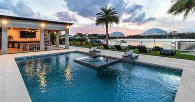 a swimming pool in the backyard of a house at Waterfront Mansion The GlamHomes in North Miami Beach
