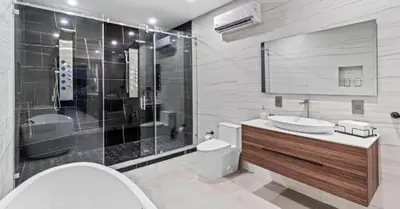 a bathroom with a toilet and a sink and a shower at Waterfront Mansion The GlamHomes in North Miami Beach