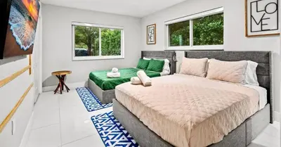 a bedroom with a large bed and a couch at Miami's Exclusive Lagoon Villa in Miami