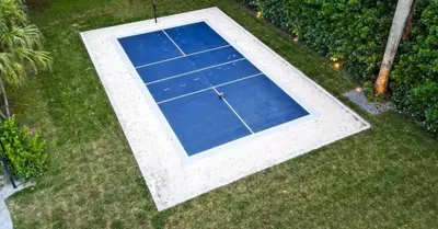 an overhead view of a tennis court in the grass at Miami's Exclusive Lagoon Villa in Miami