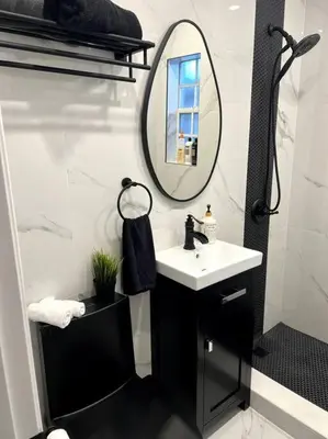 a bathroom with a sink and a mirror at Nice and Cozy guest house in Miami