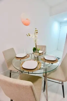 a dining room table with two chairs and a glass table at BEAUTIFUL APARTMENT FOOTSTEPS FROM THE BEACH in Miami Beach