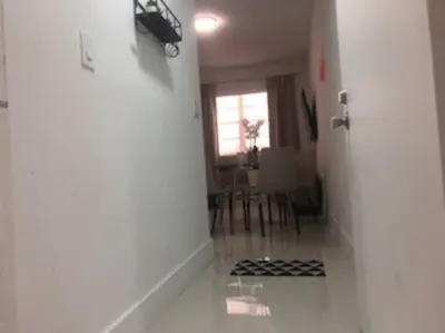 a hallway with a room with a table and a window at BEAUTIFUL APARTMENT FOOTSTEPS FROM THE BEACH in Miami Beach