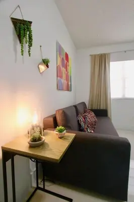 a living room with a couch and a table at BEAUTIFUL APARTMENT FOOTSTEPS FROM THE BEACH in Miami Beach