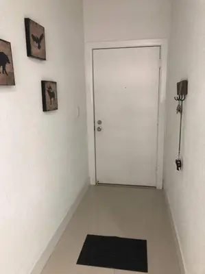 a white room with a white door and a black rug at MODERN AND ECLECTIC APARMENT A STEPS THE BEACH in Miami Beach