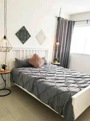 a large bed in a bedroom with a window at MODERN AND ECLECTIC APARMENT A STEPS THE BEACH in Miami Beach