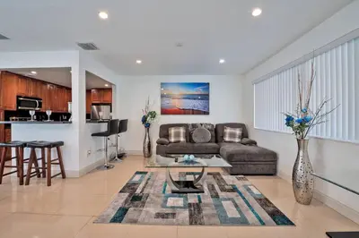 a living room with a couch and a table at Luxurious 5 bedrooms Jacuzzipool in Miramar