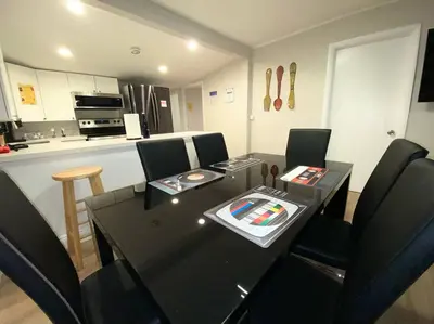 a dining room with a table and chairs and a kitchen at Unique Miami Art Escape w/ HotTub, Arcade & Murals in Miami