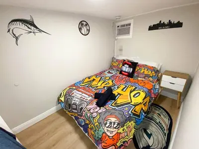 a bedroom with a bed covered in graffiti at Unique Miami Art Escape w/ HotTub, Arcade & Murals in Miami