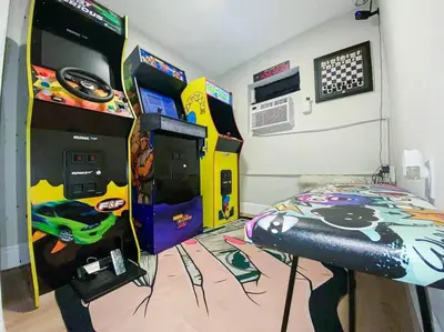 a bedroom with a video game machine and a bed at Unique Miami Art Escape w/ HotTub, Arcade & Murals in Miami